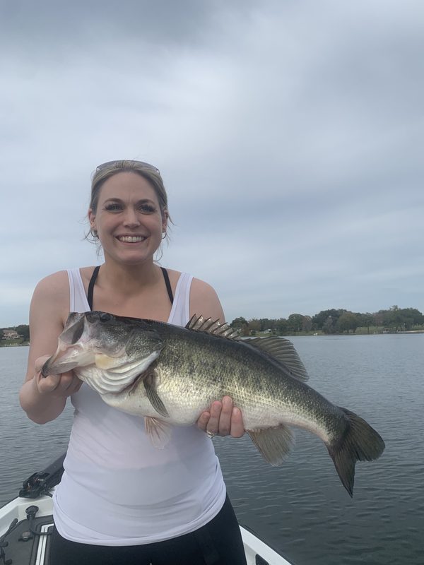 Woman angler holding a large largemouth bass on an overcast winter afternoon, Winter Haven Chain of Lakes